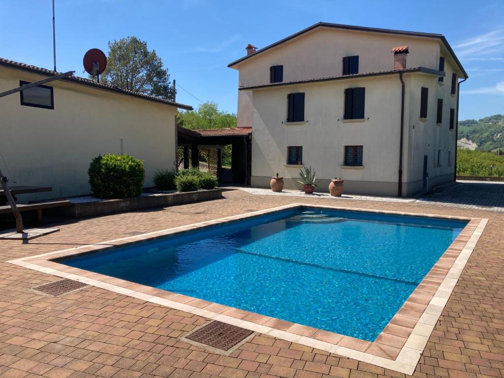 a swimming pool in front of a house at Ca’ Vanello in Borgo Tossignano