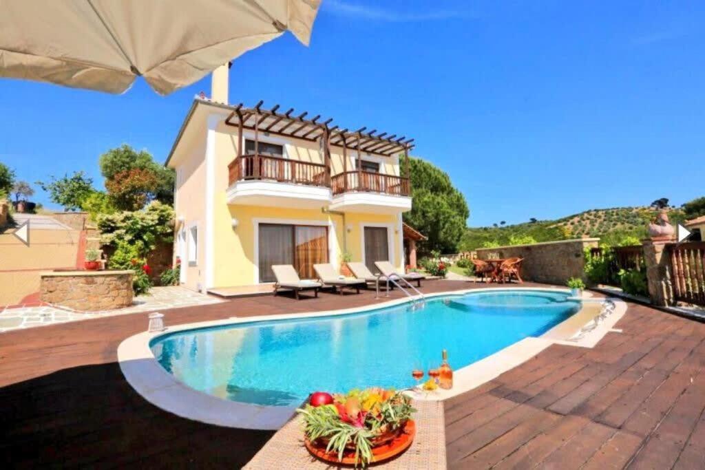 a villa with a swimming pool and a house at Luxury Villa Nefeli w Private Pool In Skiathos in Troulos