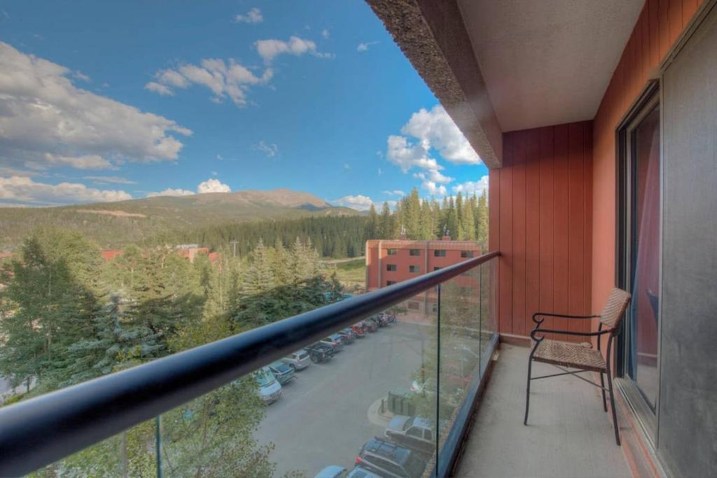 a balcony with a chair and a view of a pool at One BDR Ski in Ski Out Condo in Breckenridge