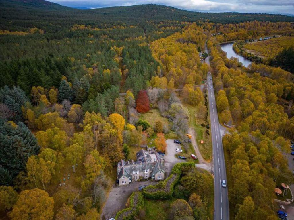 an aerial view of a house in the middle of a forest at Crannach House Apartment in Ballater