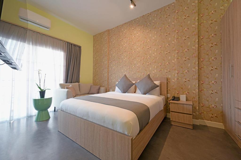 a bedroom with a large bed and a window at Comfy apart hotel in Beirut