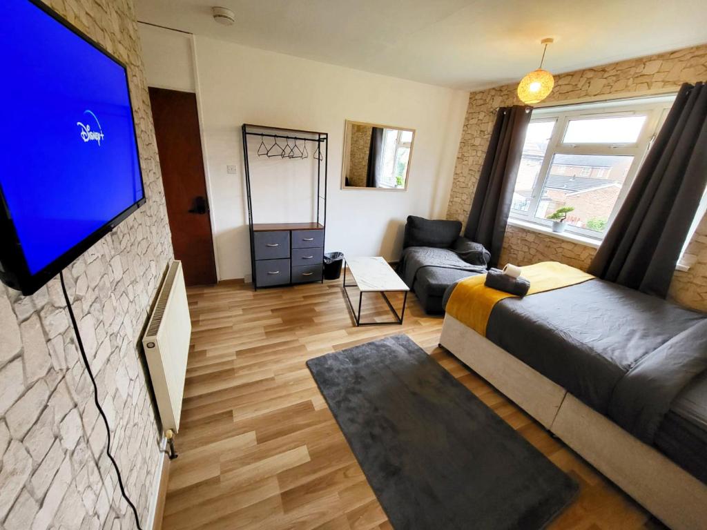 a living room with a couch and a flat screen tv at Stay Sleep Rest - Santuary in Hull