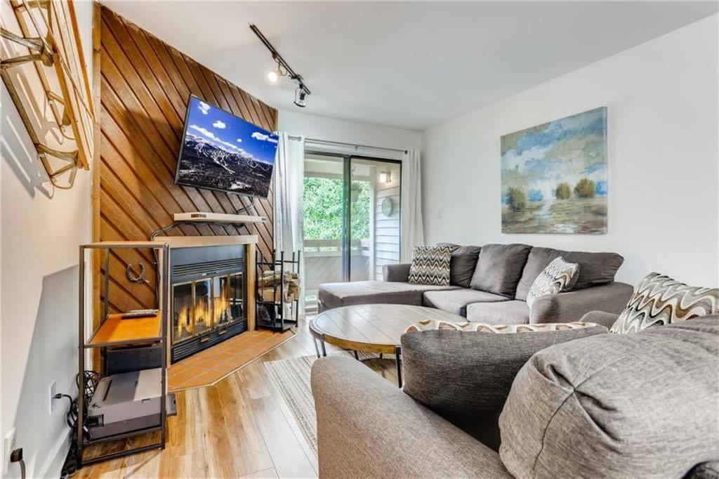 a living room with two couches and a fireplace at Lovely 2 BDR Condo Close to Skiing and Main St in Breckenridge