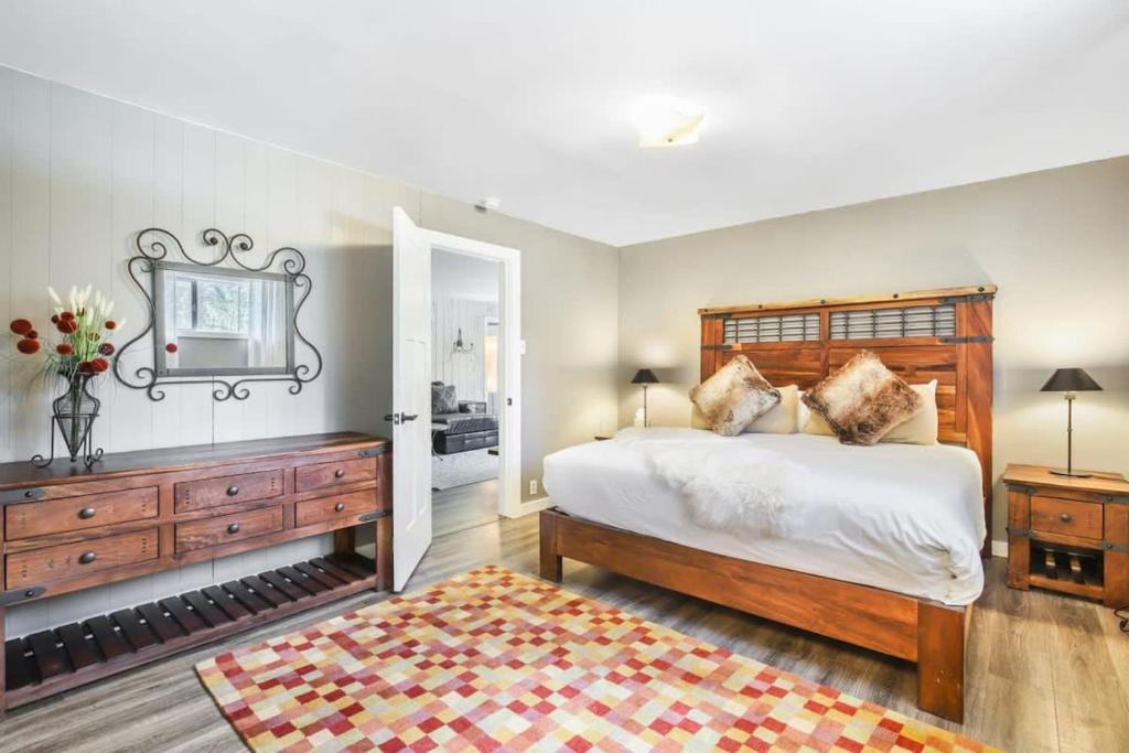 a bedroom with a large bed and a mirror at Stunning 4 BR Home Mountain Views Tranquil Setting in Breckenridge