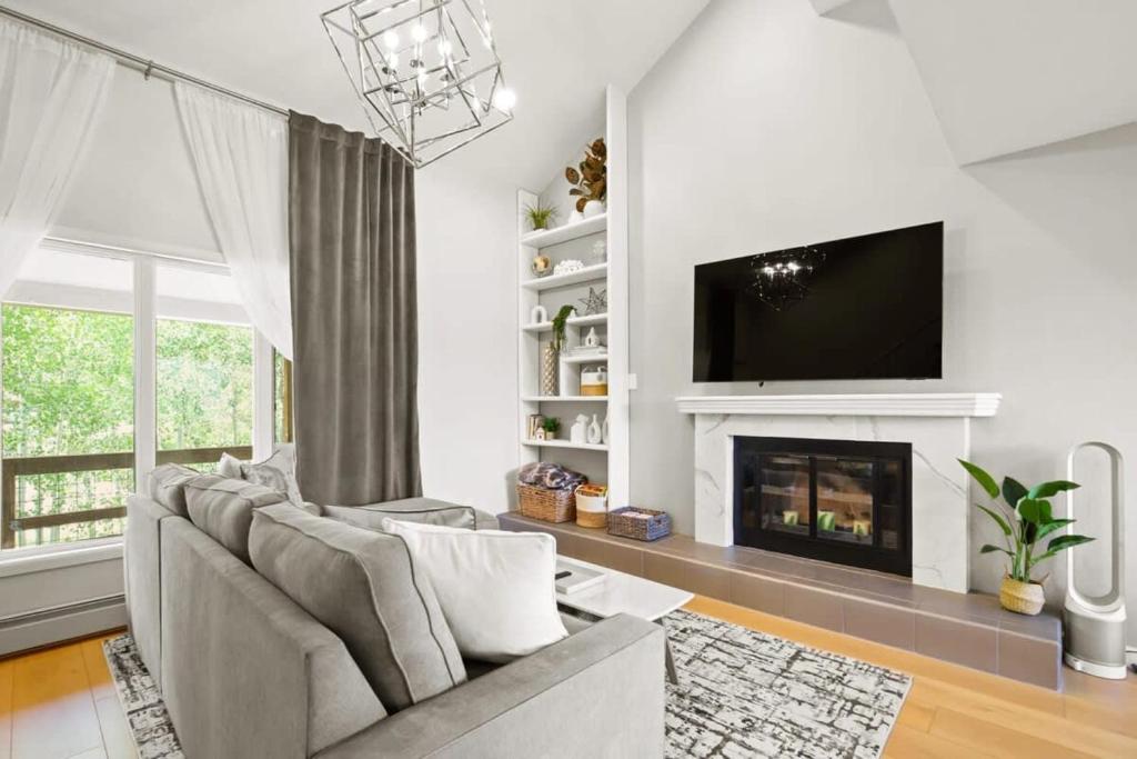a living room with a couch and a fireplace at Stunning 3BR central to Breck Keystone Copper in Silverthorne
