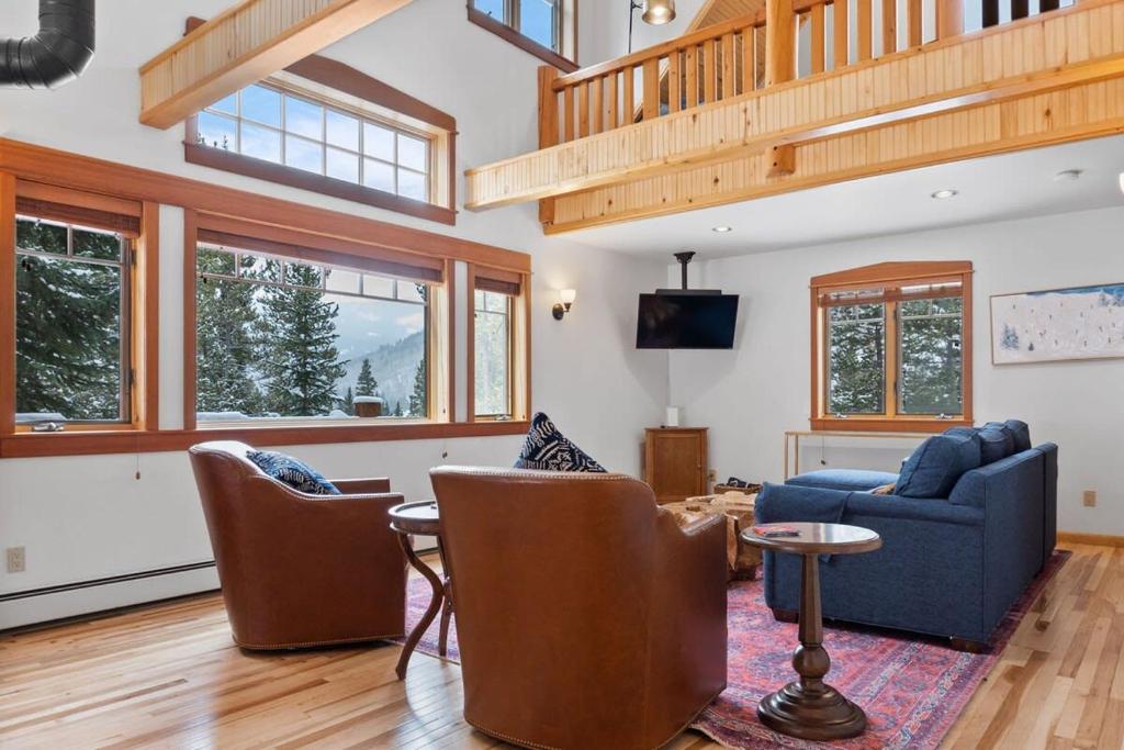 a living room with a blue couch and chairs at Serene 3BD with Stunning Views and Hot Tub in Breckenridge