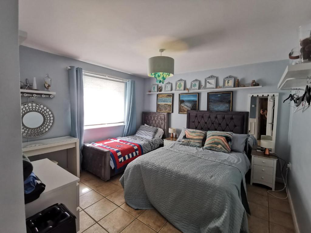 a bedroom with two beds and a couch at Coral Cove Bundoran in Bundoran