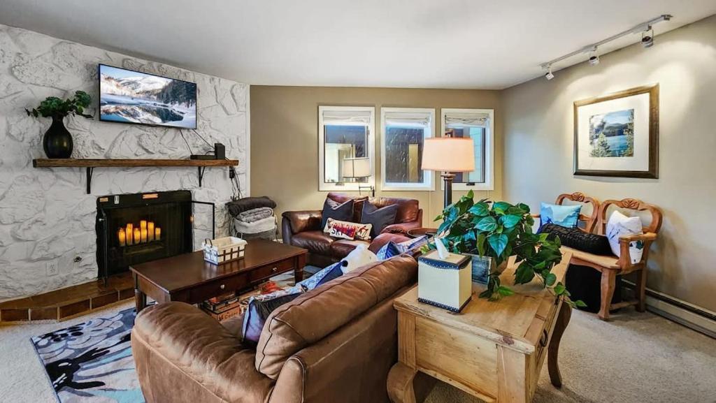 a living room with a couch and a fireplace at 2BR Condo in the Heart of Breck in Breckenridge