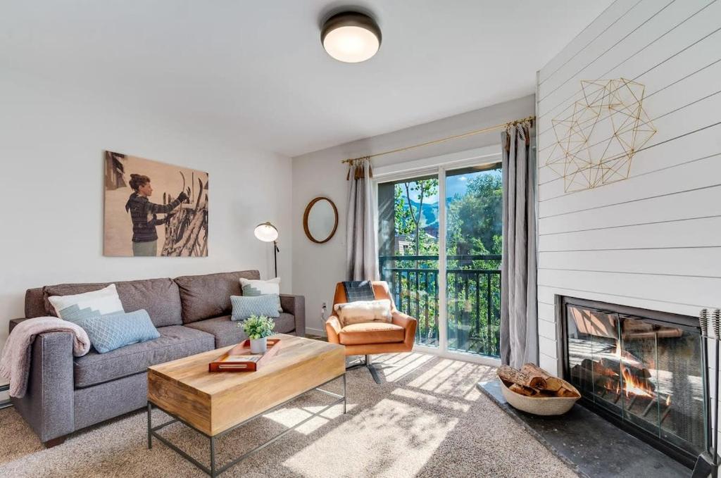 a living room with a couch and a fireplace at Gorgeous View in Town Walk to Lifts in Breckenridge