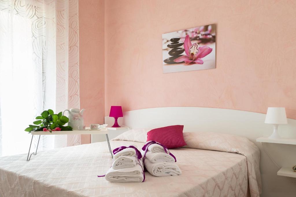 a bedroom with a bed with a pair of shoes on it at B&B Miracapri in Agropoli