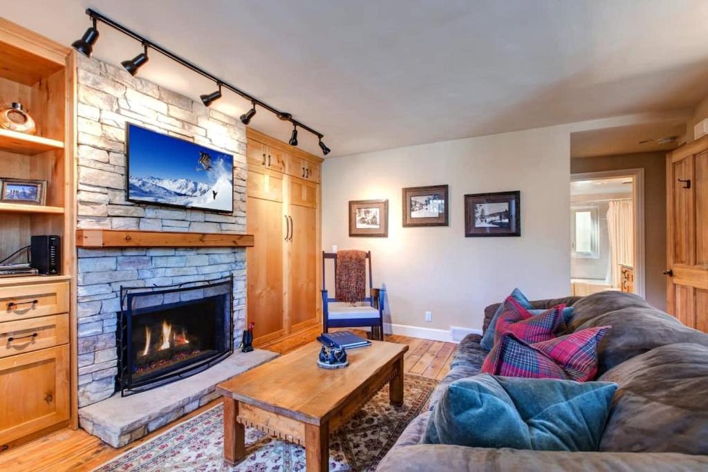 a living room with a couch and a fireplace at Quaint 2BR Retreat Heart of Town Steps from Lift in Park City