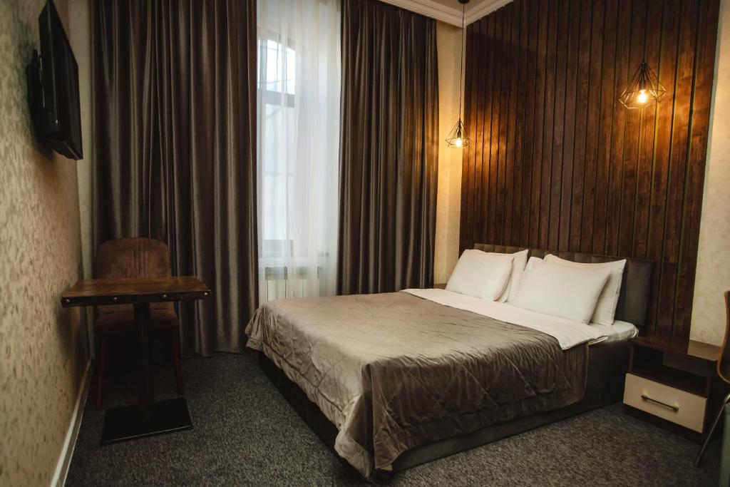 a hotel room with a bed and a window at Moss Art Boutique Hotel in Baku