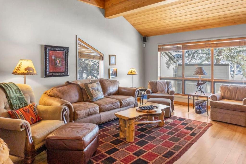 a living room with leather furniture and a large window at 3BR Townhome Incredible Location in Park City