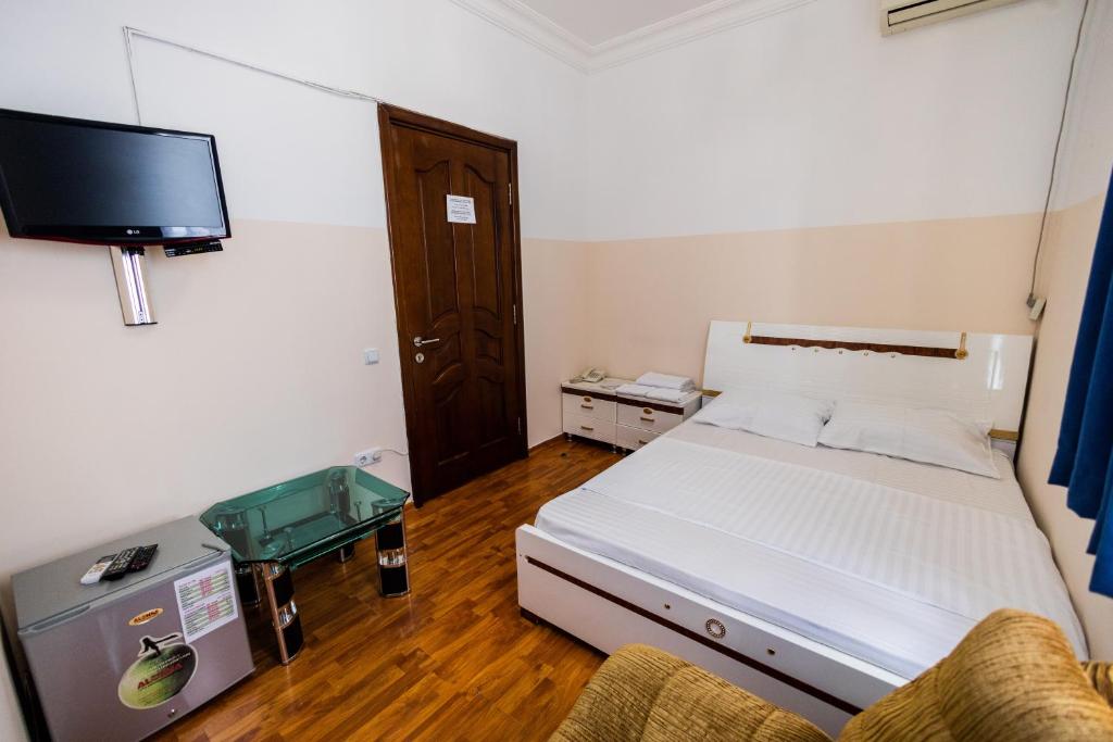 Postel nebo postele na pokoji v ubytování YAN HOTEL
