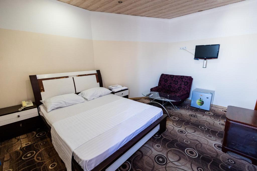 Postel nebo postele na pokoji v ubytování YAN HOTEL