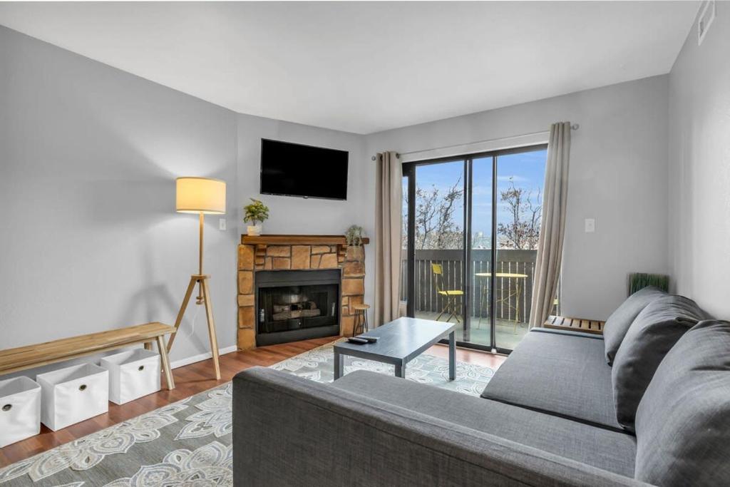 a living room with a couch and a fireplace at 2BR Condo Near Trails and Ski Resorts in Park City