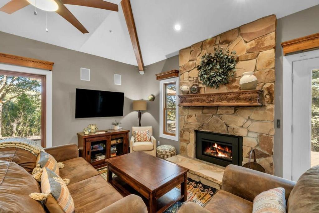 a living room with a couch and a fireplace at 2BD with Hot Tub Near Ski Resorts and Trails in Park City