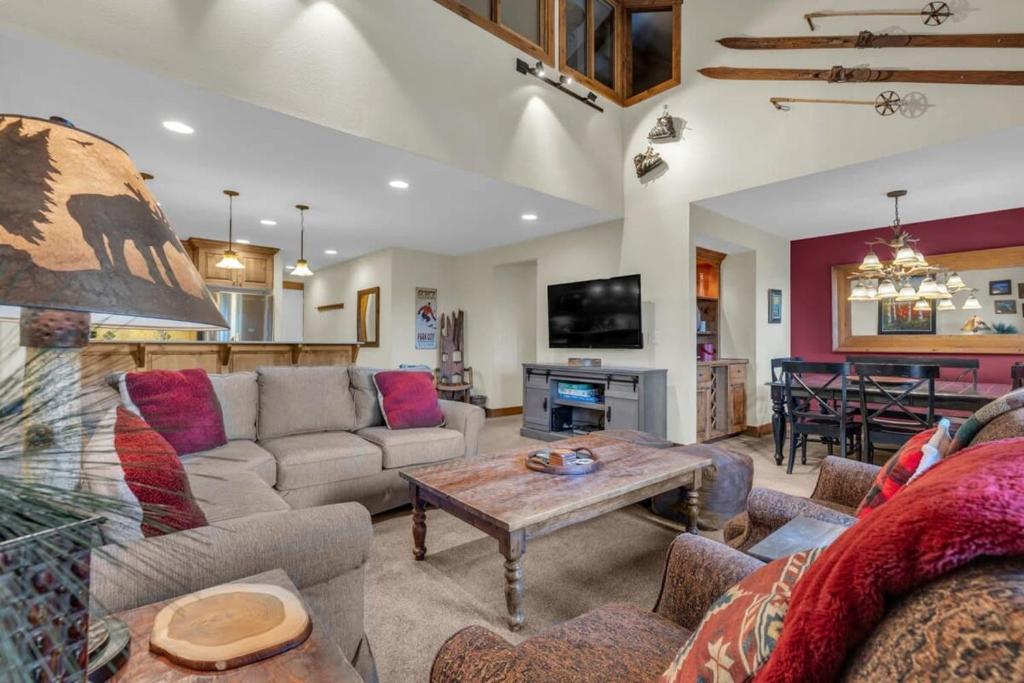 a living room with a couch and a table at Ski In Ski Out 3BR Steps from Ski Resort in Park City