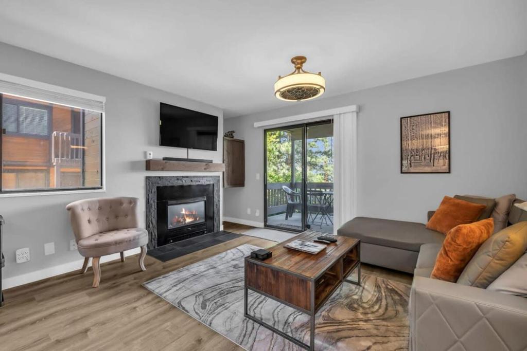 a living room with a couch and a fireplace at Cozy 1BDR Canyons Condo in Park City