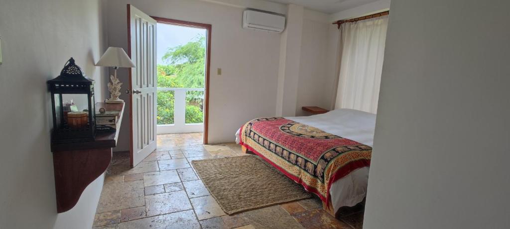 a bedroom with a bed and a large window at VILLA FLOREANA in Puerto Velasco Ibarra