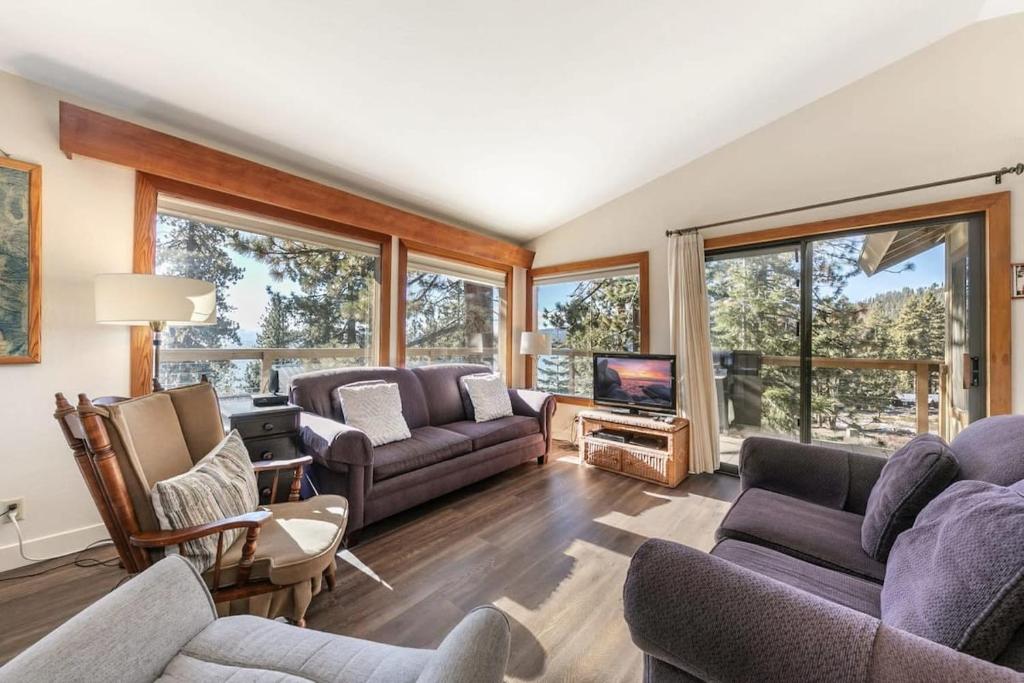 a living room with two couches and a tv at Tahoe Vista Retreat with Lake View Walk to beach in Tahoe Vista