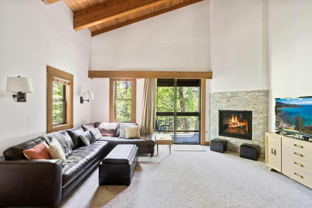 a living room with a couch and a fireplace at Bright 2BDR Next to NorthStar - 5min Walk! in Truckee