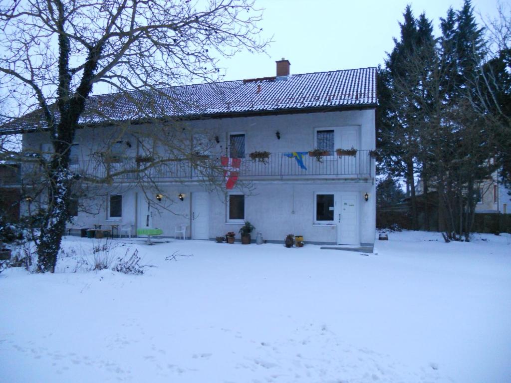 a white house with snow in front of it at Landhotel Lützen-Stadt in Lützen