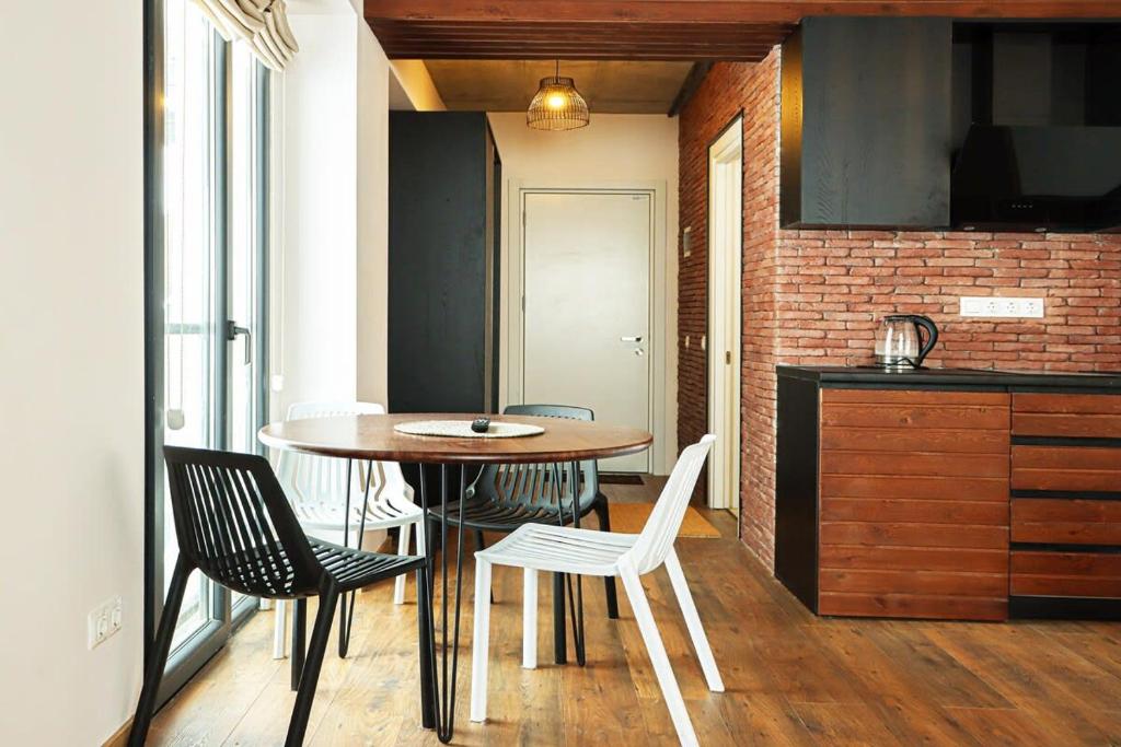 cocina con mesa y sillas en una habitación en New Gudaur Studio with Balcony By Wehost, en Gudauri