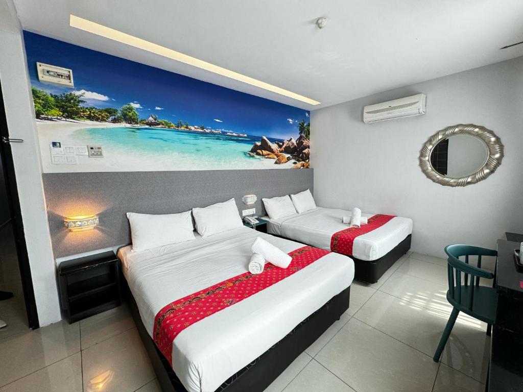 a hotel room with two beds and a painting on the wall at Best View Hotel Puchong in Puchong