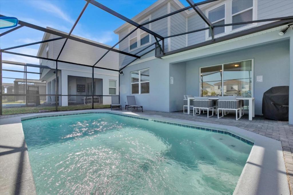 a swimming pool in front of a house at Charming Retreat in Orlando