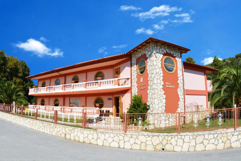 a building with a fence in front of it at Petros Italos in Neos Marmaras