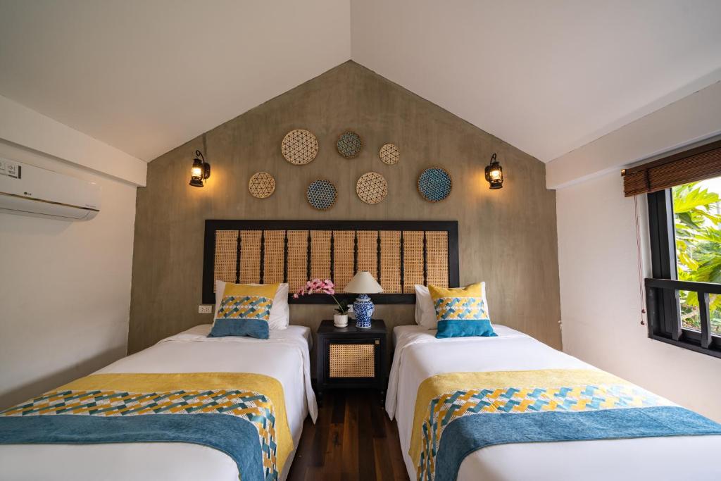 Postel nebo postele na pokoji v ubytování Nghé Garden Resort Hội An