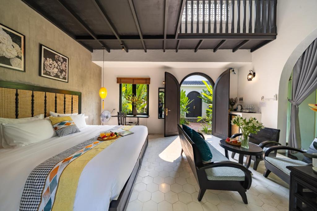 Postel nebo postele na pokoji v ubytování Nghé Garden Resort Hội An