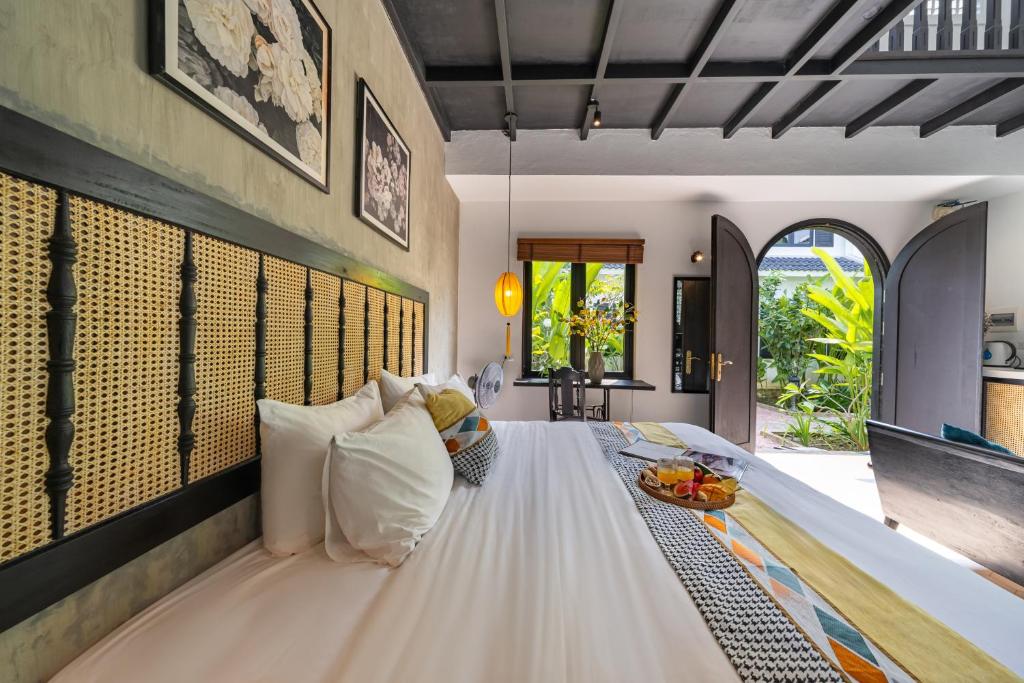 Postel nebo postele na pokoji v ubytování Nghé Garden Resort Hội An