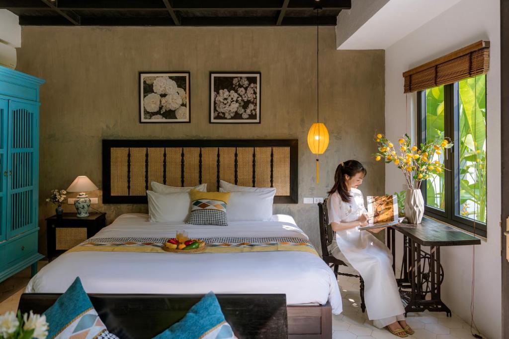 Postel nebo postele na pokoji v ubytování Nghé Garden Resort Hội An