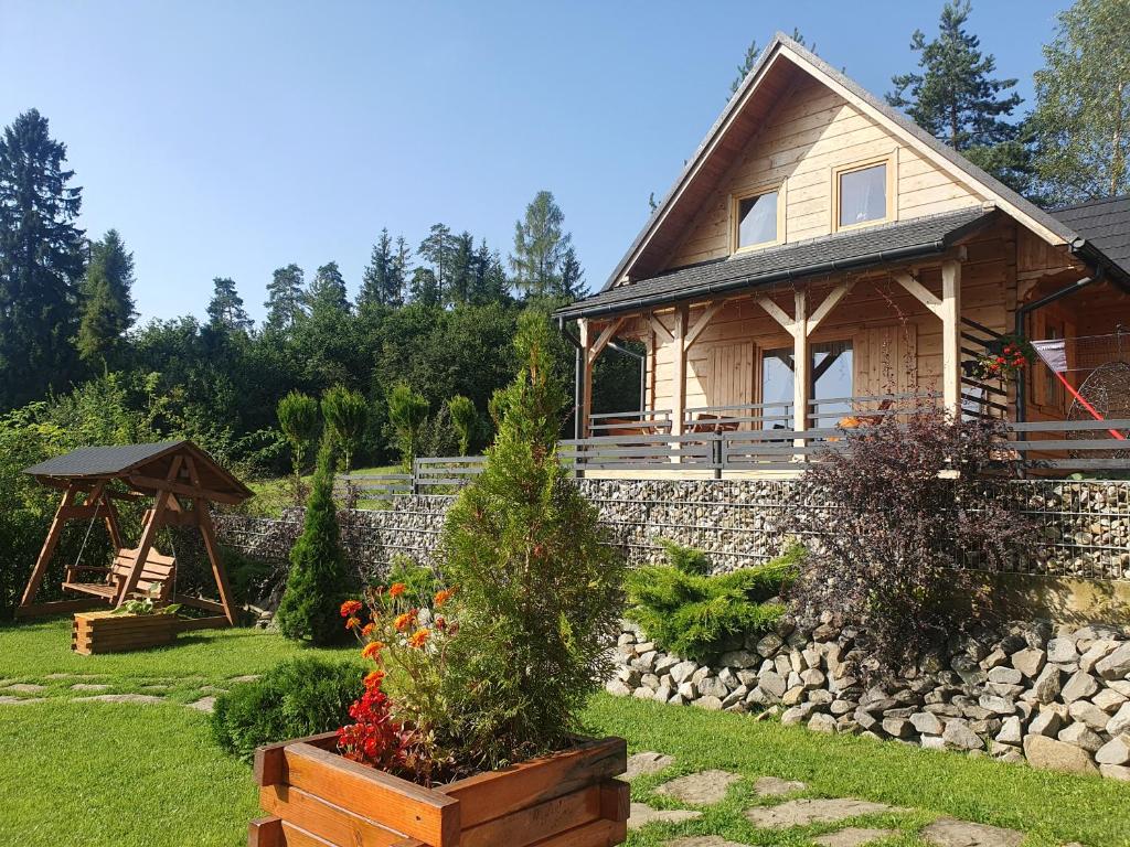 FalsztynにあるBorowikowe Zacisze drewniane domy z dostępem do balii i saunyの庭園とガゼボのある家