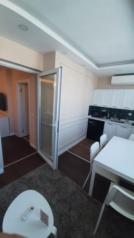 a room with a kitchen with a table and a refrigerator at Ozef Suites in Istanbul