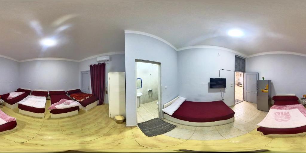 AZUR Dahab HOTEL في دهب: غرفة كبيرة بسريرين وتلفزيون