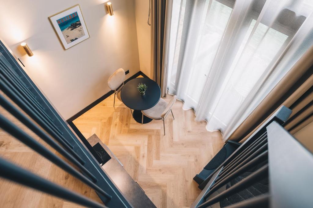 an overhead view of a living room with a piano at LVM Stays in The Hague