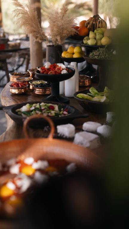 a buffet with many plates of food on a table at Moa Living in Ẕofar