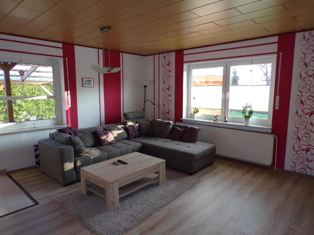 a living room with a couch and two windows at Ferienwohnung für 5 Personen ca 80 qm in Westoverledingen, Ostfriesland Landkreis Leer in Westoverledingen