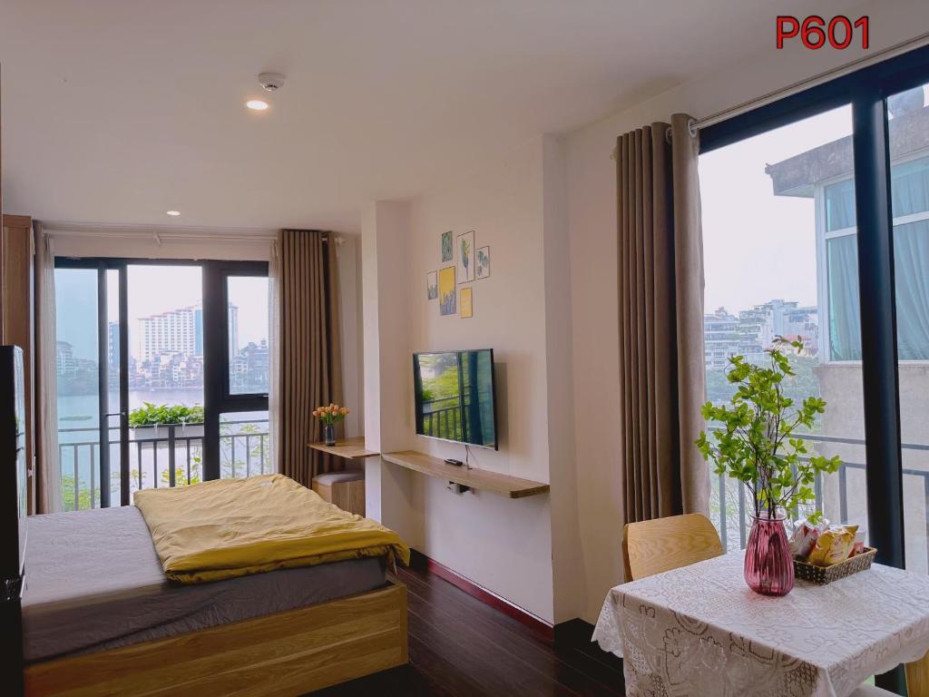 a bedroom with a bed and a balcony at WINDY LAKEVIEW STUDIO HA NOI in Hanoi