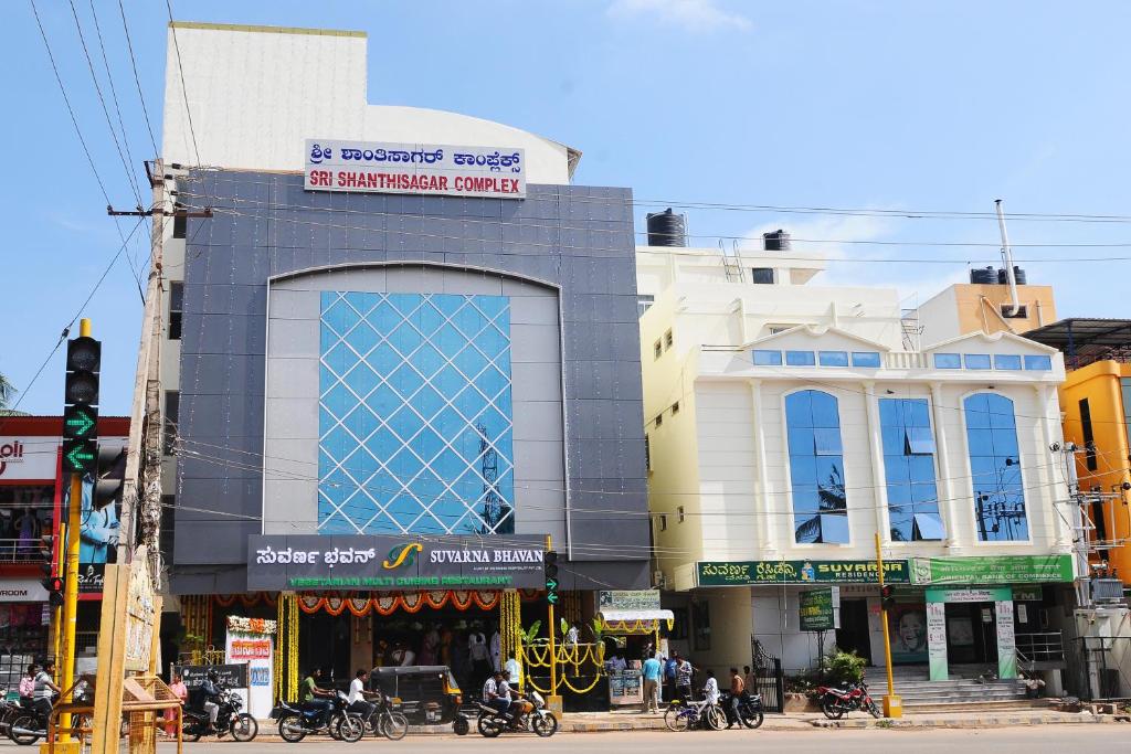 a building on the corner of a city street at Suvarna Residency in Mysore
