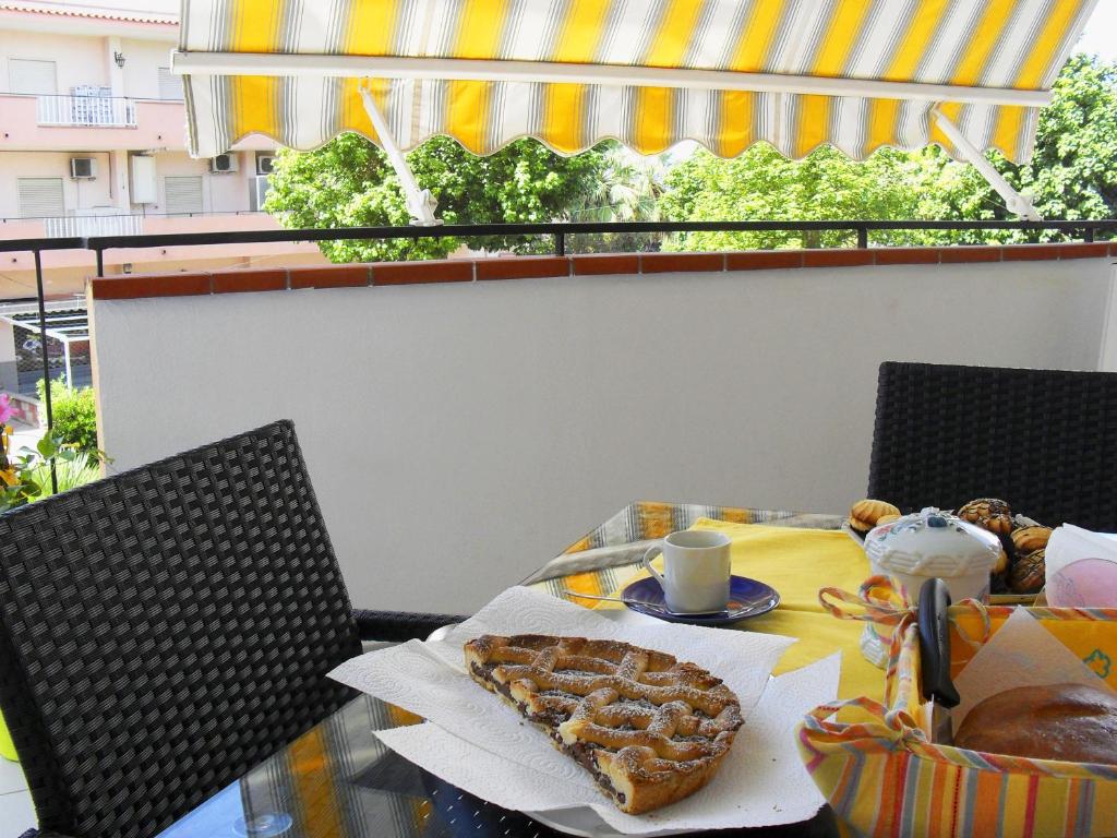 a table with a breakfast of bread and pastries at Casa Vacanze Milosa in Terme Vigliatore