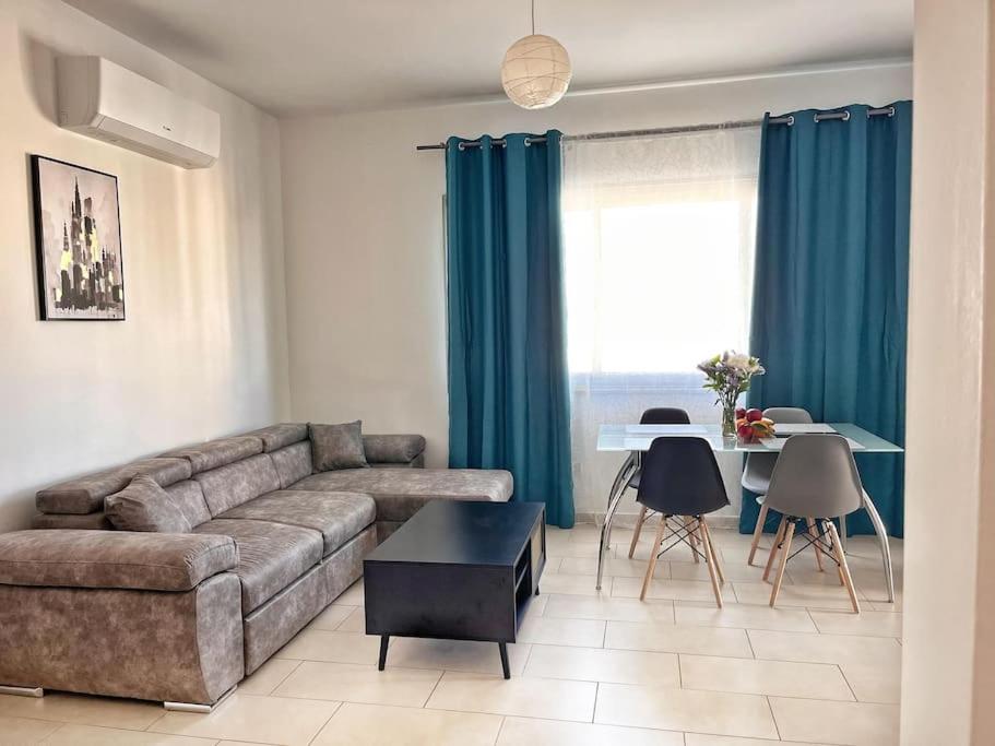 a living room with a couch and a table at TEO Apartment in Paphos