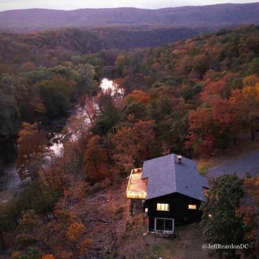 an aerial view of a house in the middle of a forest at River View Cabin - Mountain Views in Morton Grove