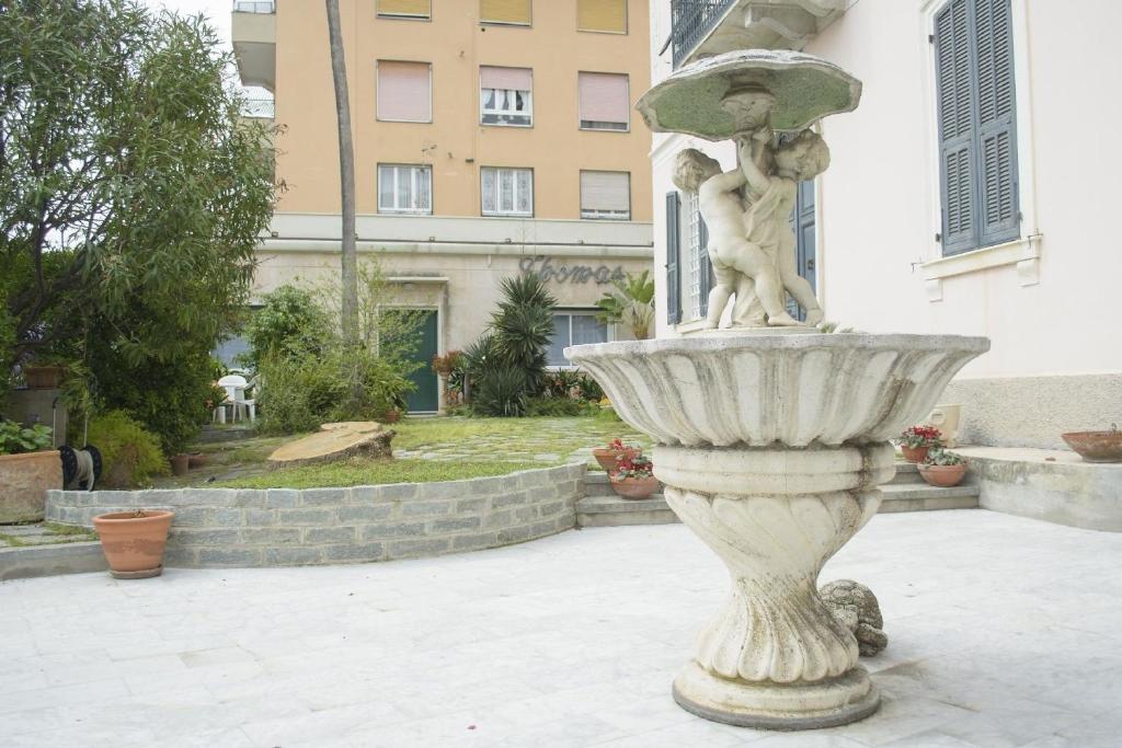 a statue of a woman in a fountain in a courtyard at Ferienwohnung für 4 Personen ca 75 qm in Imperia-Porto Maurizio, Italienische Riviera Italienische Westküste in Imperia