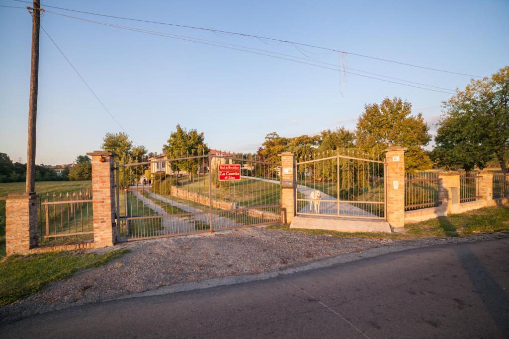 a gate with a dog inside of it at La Casetta di Lina in Carbonara Scrivia