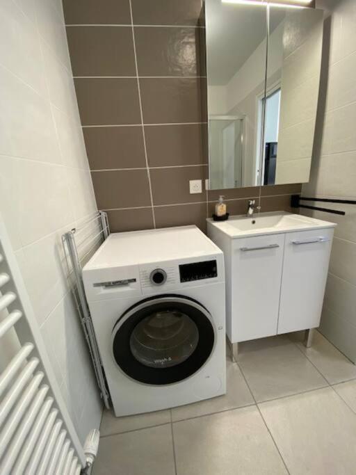 a washing machine in a bathroom with a sink at Bel appartement avec vue sur la Baie d&#39;Authie in Berck-sur-Mer