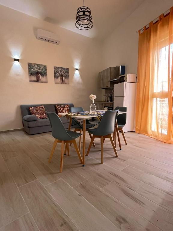 a living room with a table and chairs and a couch at Casa vacanza Sofiu' in Mazara del Vallo
